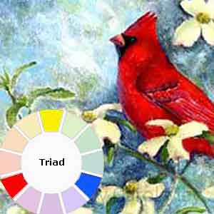 A cardinal painting done with a triad painting color scheme.