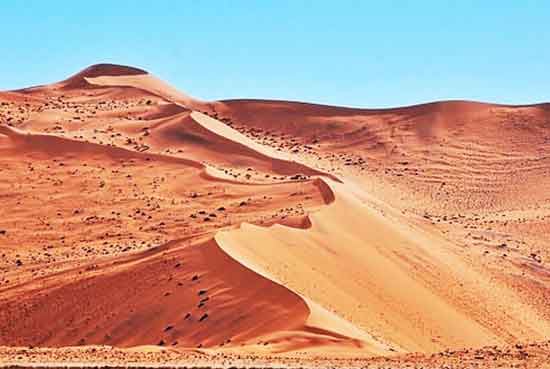 Photo of desert sand dunes with a blue sky. Painting values is an excellent idea for beginning artists.