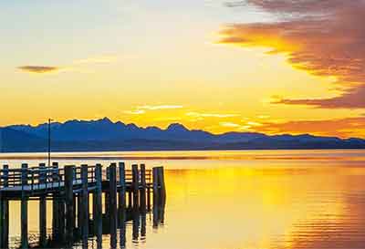 A stunning sunset over water. The brilliant colors of a sunset are great painting ideas.