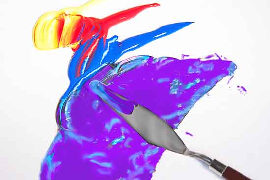 Mixing paint colors with a palette knife. Oil and acrylic colors may be mixed with a palette knife.