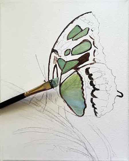 An angle brush works great for painting tight spaces. Start painting the butterfly's spots.